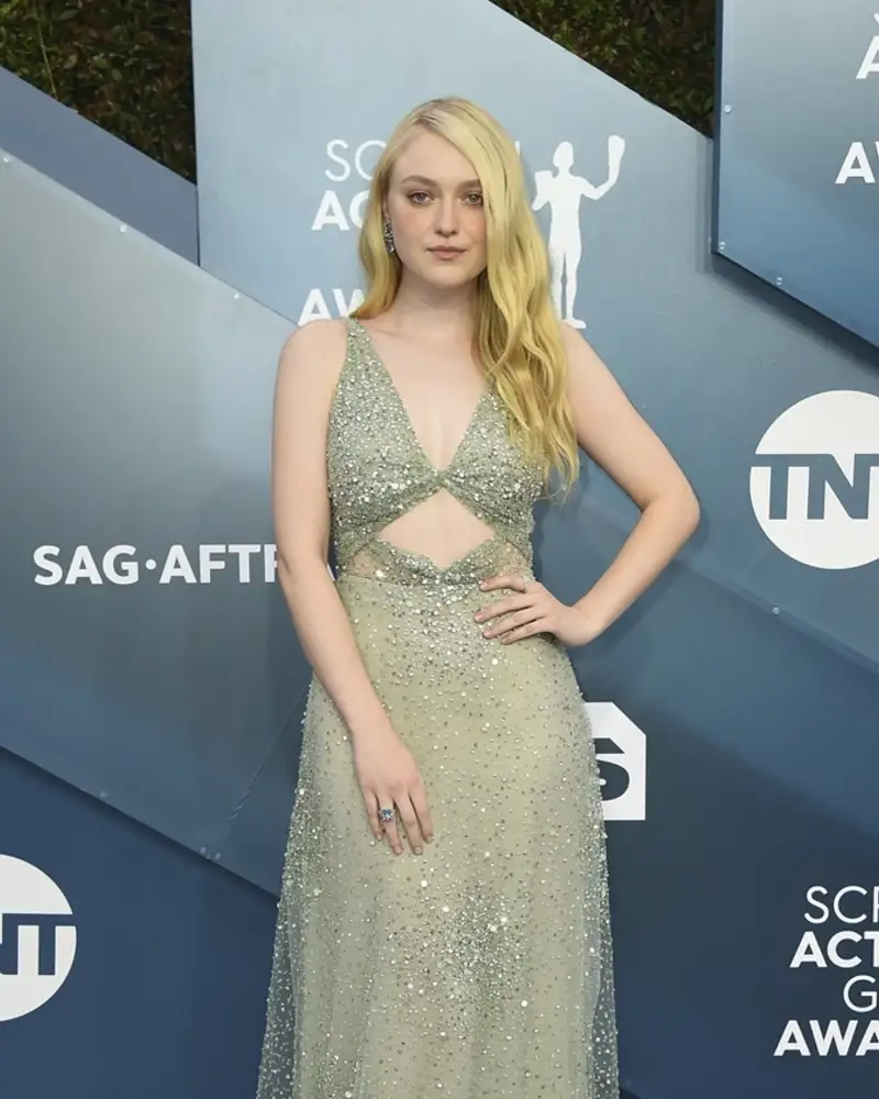Dakota Fanning attending a Chanel event in a classic couture dress